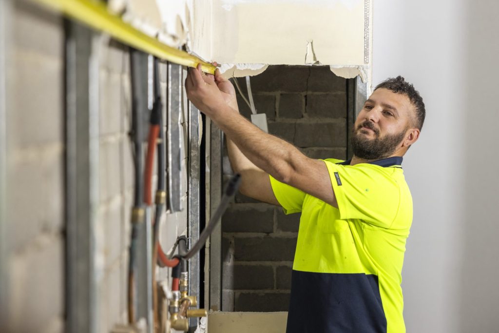 Tradesman using measuring tape